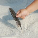toddler arm and feather